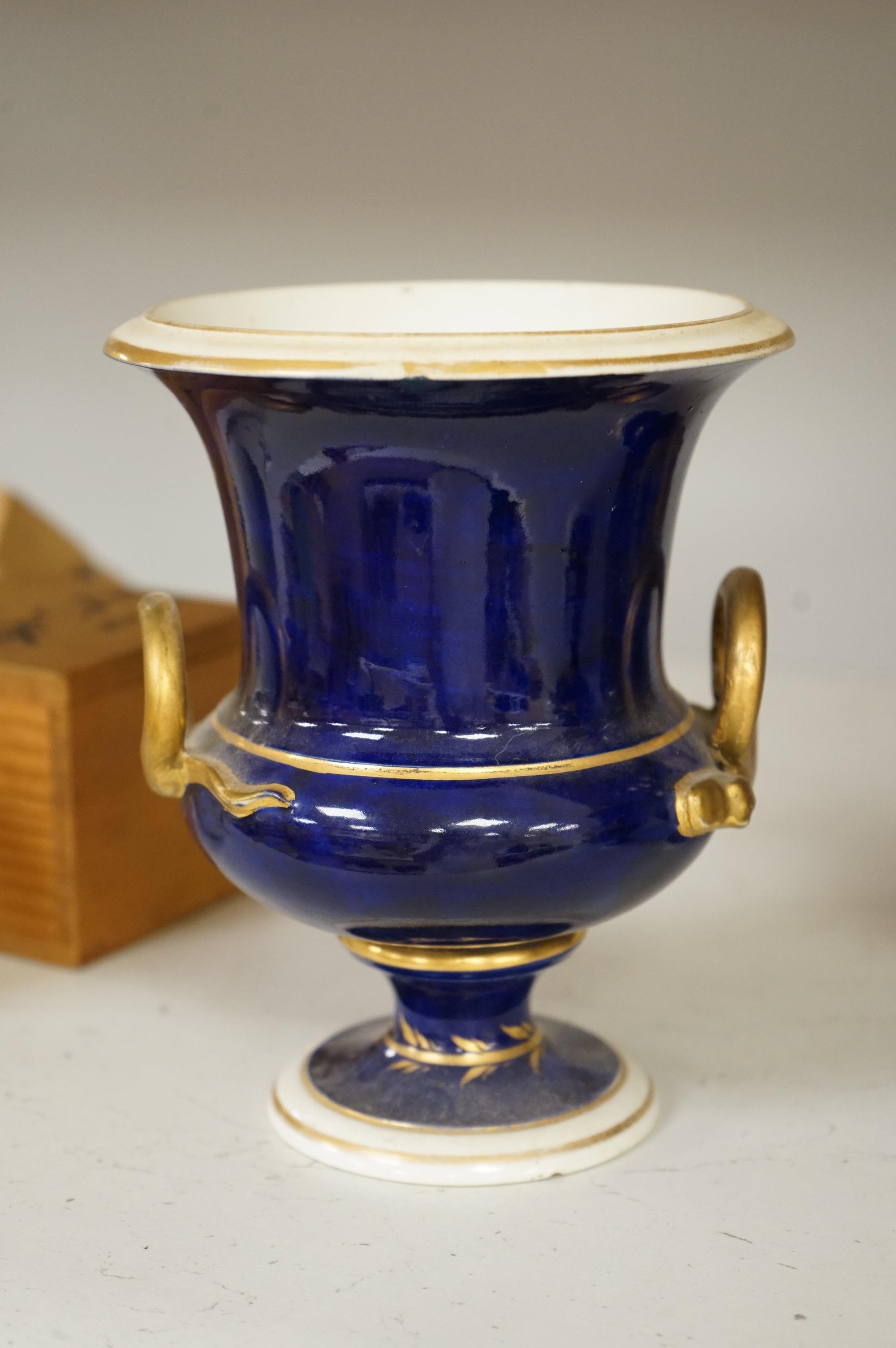 A set of three Derby campana vases, painted with named views, circa 1820, tallest 20.5cm